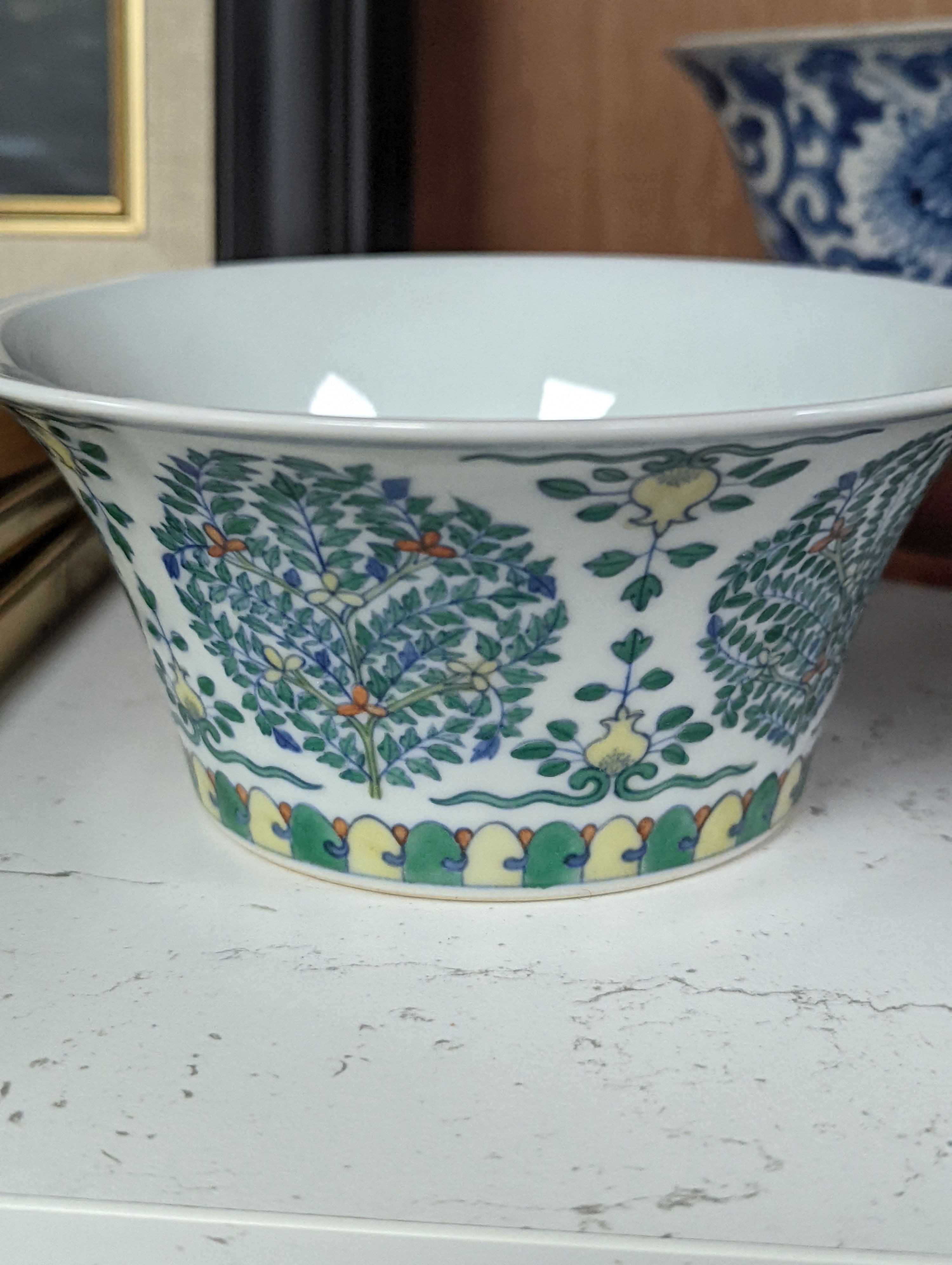 A Chinese blue and white bowl, Kangxi, 15cm. diam., a famille rose teapot stand, Yongzheng, and two doucai bowls